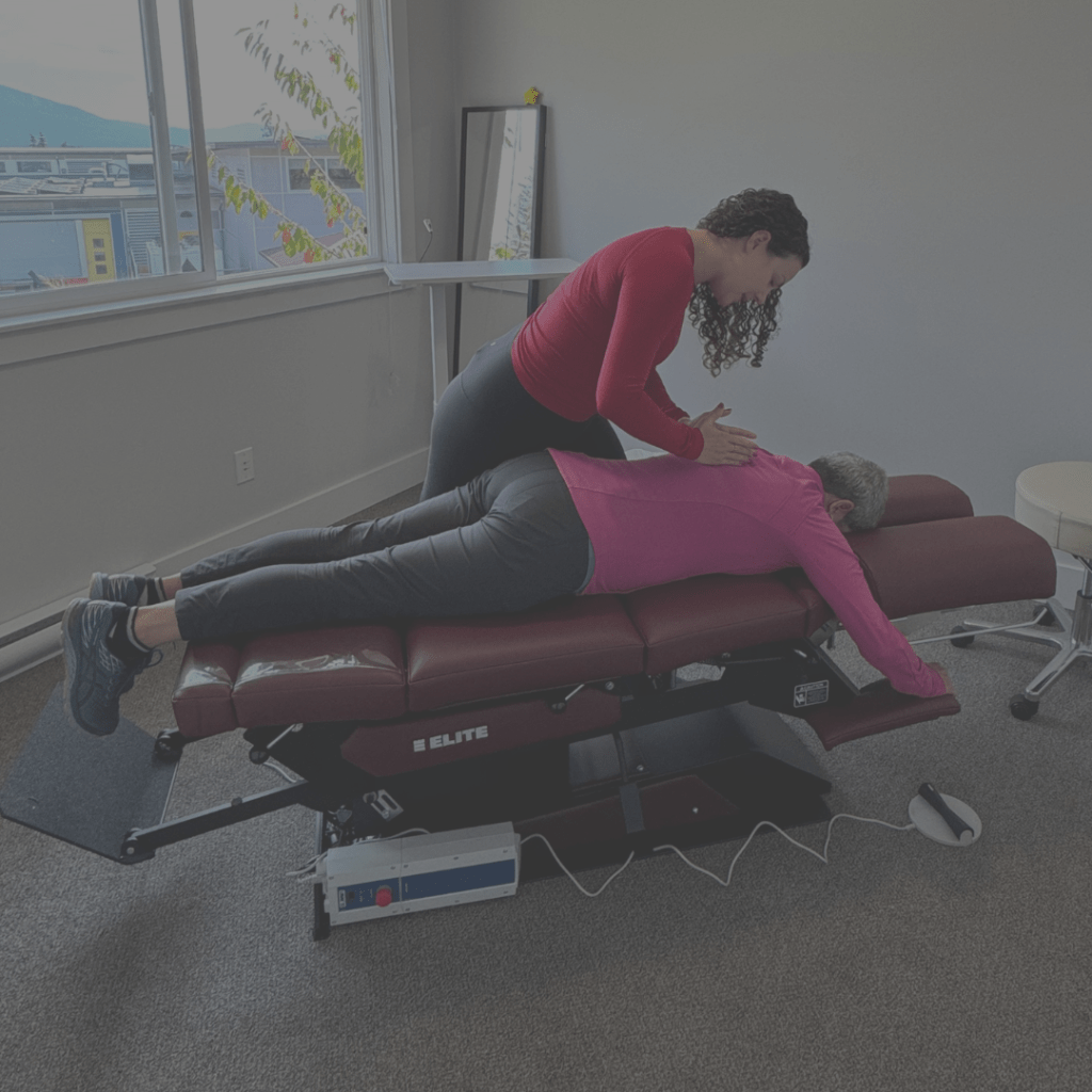 Dr. Janet Belliveau, best chiropractor on the Coast adjusts elderly patient.